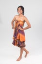 Beautiful tan female model in strapless dress posing on white ba Royalty Free Stock Photo