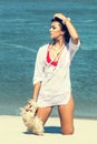 Beautiful tanned woman at the sea coast fashion photo. Beach travel. Summer vibes Royalty Free Stock Photo
