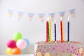 Beautiful tasty birthday cake with candles on blurred background