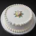 Beautiful tasty decorated with flowers white cake with white cream on white table