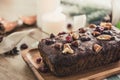 Beautiful tasty dried mixed nut Christmas fruit cake on wooden table
