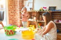 Beautiful teacher and blond student toddler girl playing with dinosaurs at kindergarten Royalty Free Stock Photo