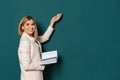 Beautiful teacher with book pointing at chalkboard Royalty Free Stock Photo