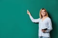 Beautiful teacher with book pointing at chalkboard Royalty Free Stock Photo