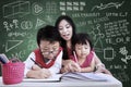 Beautiful teacher help children to write in class Royalty Free Stock Photo