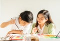 beautiful teacher teach cute little children painting color on paper art in education classroom, focus at teacher. Royalty Free Stock Photo