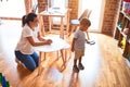 Beautiful teacher and toddler boy holding magnifying glass at kindergarten Royalty Free Stock Photo