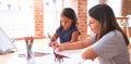 Beautiful teacher and toddler girl drawing draw using colored pencils at kindergarten Royalty Free Stock Photo