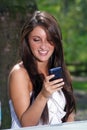 Beautiful Teen Brunette Texting Outdoors Royalty Free Stock Photo