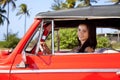 Beautiful teen driving old car and smiling Royalty Free Stock Photo