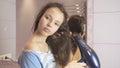 Beautiful teen girl dries hair a hairdryer in bathroom Royalty Free Stock Photo