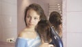 Beautiful teen girl dries hair a hairdryer in bathroom Royalty Free Stock Photo