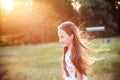 Beautiful Teen Girl is enjoying nature in the park at Summer sunset Royalty Free Stock Photo