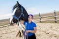 Beautiful teen girl on the farm with her horse. Royalty Free Stock Photo