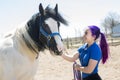 Beautiful teen girl on the farm with her horse. Royalty Free Stock Photo