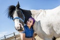 Beautiful teen girl on the farm with her horse. Royalty Free Stock Photo