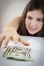 Beautiful teen girl grabs US dollars Royalty Free Stock Photo