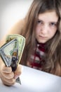 Beautiful teen girl grabs US dollars Royalty Free Stock Photo