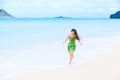 Beautiful teen girl in green dress running along Hawaiian beach Royalty Free Stock Photo