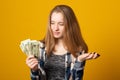 Beautiful teen girl holding dollars. Happy girl holding money banknotes and celebrating Royalty Free Stock Photo