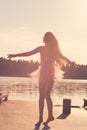 Beautiful Teen Girl with long flowing hair is dancing  in the wind against the background of the sea Royalty Free Stock Photo