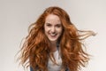 Beautiful teen girl with long ginger hair laughing at camera Royalty Free Stock Photo