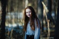 Beautiful teen girl with long hair posing for a portrait in a pine forest Royalty Free Stock Photo