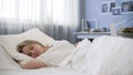 Beautiful teen girl peacefully sleeping in bad, relaxing in morning, rest time Royalty Free Stock Photo