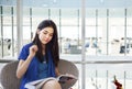 Beautiful teen girl reading magazine in office Royalty Free Stock Photo