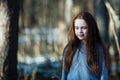 Beautiful teen girl with  long hair posing for a portrait in a pine forest Royalty Free Stock Photo