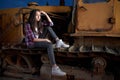 Beautiful teen girl sitting on an old tractor Royalty Free Stock Photo