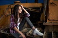 Beautiful teen girl sitting on an old tractor Royalty Free Stock Photo