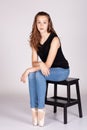 Beautiful teen girl sitting straight looking at the camera