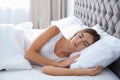 Beautiful teen girl sleeping with comfortable pillow in bed Royalty Free Stock Photo