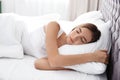 Beautiful teen girl sleeping with comfortable pillow in bed