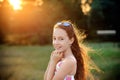 Beautiful Teen Girl is smiling and  enjoying nature in the park at Summer sunset Royalty Free Stock Photo