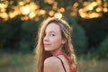 Beautiful Teen Girl is smiling and  enjoying nature in the park at Summer sunset Royalty Free Stock Photo