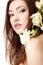 beautiful teen girl smiling and with flower narcissus and looking at camera