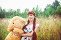 Woman with a Teddy bear in nature Royalty Free Stock Photo