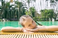 Beautiful teen irk relax at poolside in Thailand. Look in camera. Headshot. Beauty, vacation, healthy lifestyle Royalty Free Stock Photo