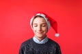 Beautiful teen wearing Santa hat smiling with eyes closed makes a wish for new year Royalty Free Stock Photo