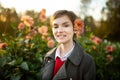 Beautiful teenage girl in blossoming dahlia field. Child picking fresh flowers in dahlia meadow on sunny autumn day Royalty Free Stock Photo