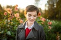 Beautiful teenage girl in blossoming dahlia field. Child picking fresh flowers in dahlia meadow on sunny autumn day Royalty Free Stock Photo