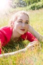 Beautiful teenage girl dreaming, relaxing in the grass for wellbeing Royalty Free Stock Photo