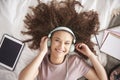 Beautiful teenage girl listening to music in her bed Royalty Free Stock Photo