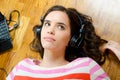 Beautiful teenage girl listening to music from notebook Royalty Free Stock Photo