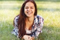 Beautiful teenage girl lying on field of green grass Royalty Free Stock Photo