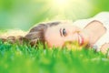 Beautiful teenage girl lying on green grass Royalty Free Stock Photo