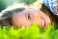 Beautiful teenage girl lying on green grass Royalty Free Stock Photo