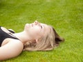 Beautiful Teenage Girl lying on her back in the grass Royalty Free Stock Photo